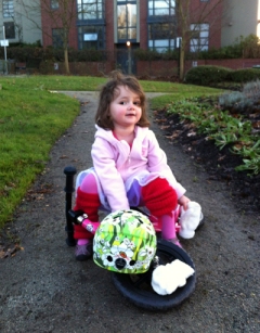 Poppy taking a breather while she goes for a spin on her Strider bike. 
